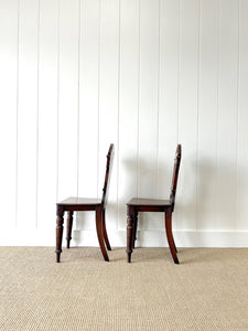 A Pair of English Oak Carved Hall Chairs