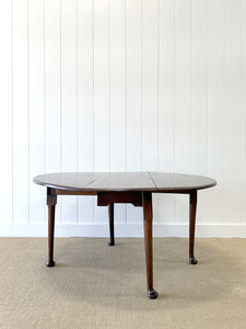 An Antique Cuban Mahogany Drop Leaf Dining Table with Pad Feet