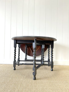 An Antique English Ebonized Country Oak Drop Leaf Gate Leg Table