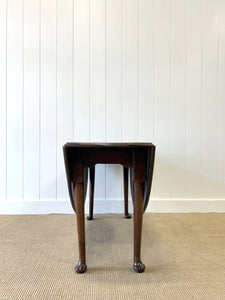 An Antique Cuban Mahogany Drop Leaf Dining Table with Pad Feet