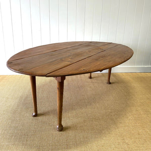 An Antique Irish Pine Oval Drop Leaf Kitchen Dining Table with Spoon Feet