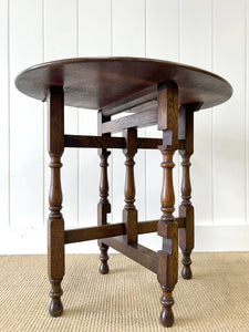 An Antique English Country Oak Coaching Gate Leg Table