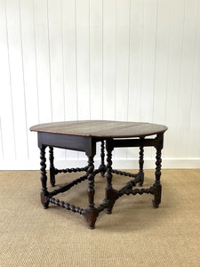 An Antique English Country Oak Drop Leaf Gate Leg Table