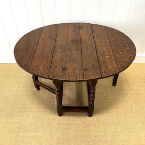 An Antique English Country Barley Twist Oak Drop Leaf Gate Leg Table