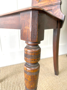 A Pair of English Oak Carved Hall Chairs