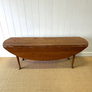 An Antique Irish Pine Oval Drop Leaf Kitchen Dining Table with Spoon Feet