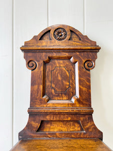 A Pair of English Oak Carved Hall Chairs