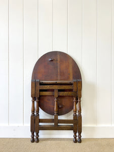 An Antique English Country Oak Coaching Gate Leg Table