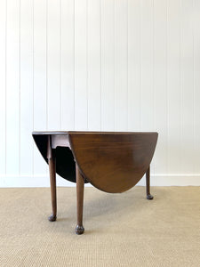 An Antique Cuban Mahogany Drop Leaf Dining Table with Pad Feet