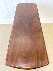 An Antique Cuban Mahogany Drop Leaf Dining Table with Pad Feet