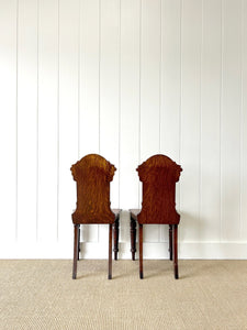 A Pair of English Oak Carved Hall Chairs