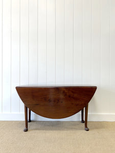 An Antique Cuban Mahogany Drop Leaf Dining Table with Pad Feet