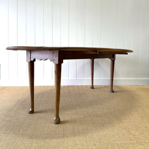 An Antique Irish Pine Oval Drop Leaf Kitchen Dining Table with Spoon Feet