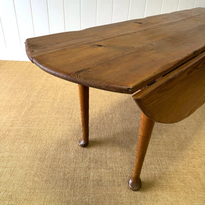 An Antique Irish Pine Oval Drop Leaf Kitchen Dining Table with Spoon Feet