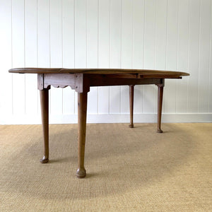 An Antique Irish Pine Oval Drop Leaf Kitchen Dining Table with Spoon Feet