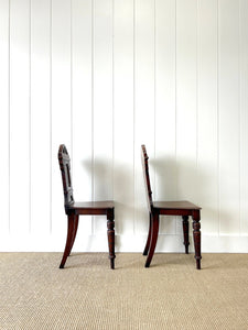 A Pair of English Oak Carved Hall Chairs