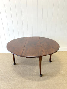 An Antique Cuban Mahogany Drop Leaf Dining Table with Pad Feet