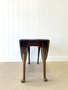 An Antique Cuban Mahogany Drop Leaf Dining Table with Pad Feet