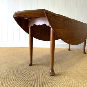 An Antique Irish Pine Oval Drop Leaf Kitchen Dining Table with Spoon Feet