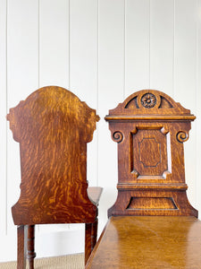 A Pair of English Oak Carved Hall Chairs