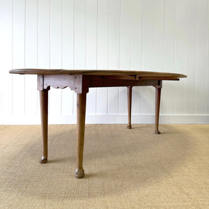 An Antique Irish Pine Oval Drop Leaf Kitchen Dining Table with Spoon Feet