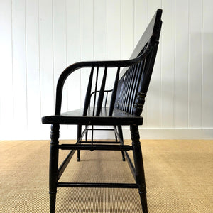 An Antique Ebonized Bench