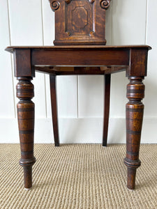 A Pair of English Oak Carved Hall Chairs