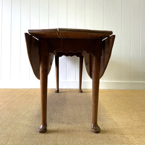 An Antique Irish Pine Oval Drop Leaf Kitchen Dining Table with Spoon Feet