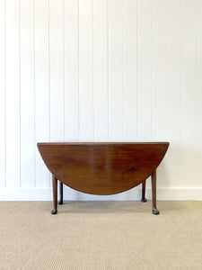 An Antique Cuban Mahogany Drop Leaf Dining Table with Pad Feet