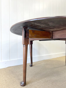 An Antique Cuban Mahogany Drop Leaf Dining Table with Pad Feet