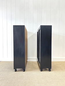 A Pair of English Teak Ebonized Bookcases