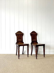 A Pair of English Oak Carved Hall Chairs