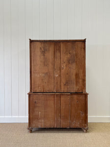 A 19th Century English Pine Bookcase with Glazed Top Doors