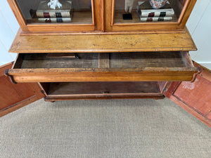 A 19th Century English Pine Bookcase with Glazed Top Doors