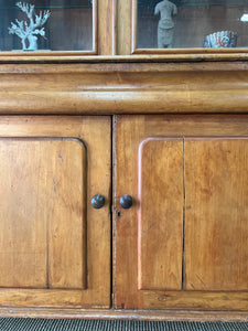 A 19th Century English Pine Bookcase with Glazed Top Doors