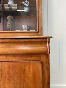 A 19th Century English Pine Bookcase with Glazed Top Doors