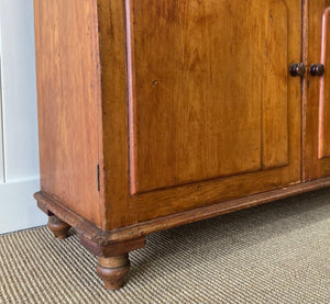 A 19th Century English Pine Bookcase with Glazed Top Doors