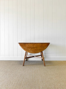 An Ercol Elm & Beech Drop Leaf Dining Table