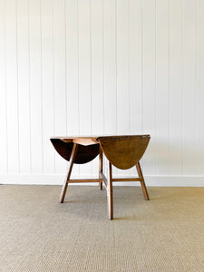 An Ercol Elm & Beech Drop Leaf Dining Table