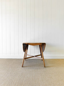 An Ercol Elm & Beech Drop Leaf Dining Table