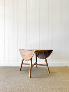 An Ercol Elm & Beech Drop Leaf Dining Table