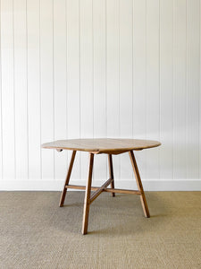 An Ercol Elm & Beech Drop Leaf Dining Table