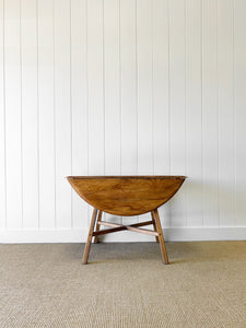 An Ercol Elm & Beech Drop Leaf Dining Table