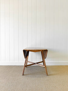 An Ercol Elm & Beech Drop Leaf Dining Table