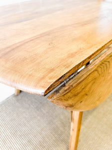 An Ercol Elm & Beech Drop Leaf Dining Table