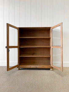 A 19th Century English Pine Glazed Bookcase on Bun Feet