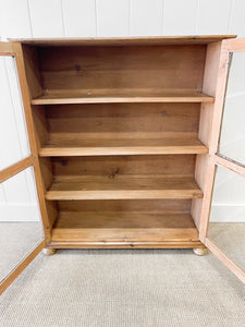 A 19th Century English Pine Glazed Bookcase on Bun Feet