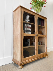 A 19th Century English Pine Glazed Bookcase on Bun Feet