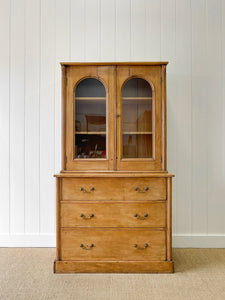 A 19th Century English Pine Bookcase with Arched Doors