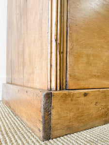 A 19th Century English Pine Bookcase with Arched Doors